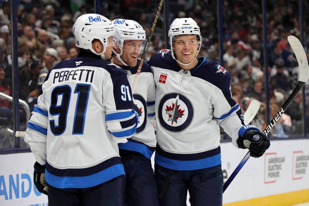 PAUL VERNON / THE ASSOCIATED PRESS
Winnipeg Jets forward Nikolaj Ehlers, centre, celebrates his second goal against the Columbus Blue Jackets with teammate forward Cole Perfetti, left, and forward Vladislav Namestnikov during the first period of an NHL hockey game in Columbus, Ohio, Friday. Ehlers scored three during the game and the Jets won 6-2.