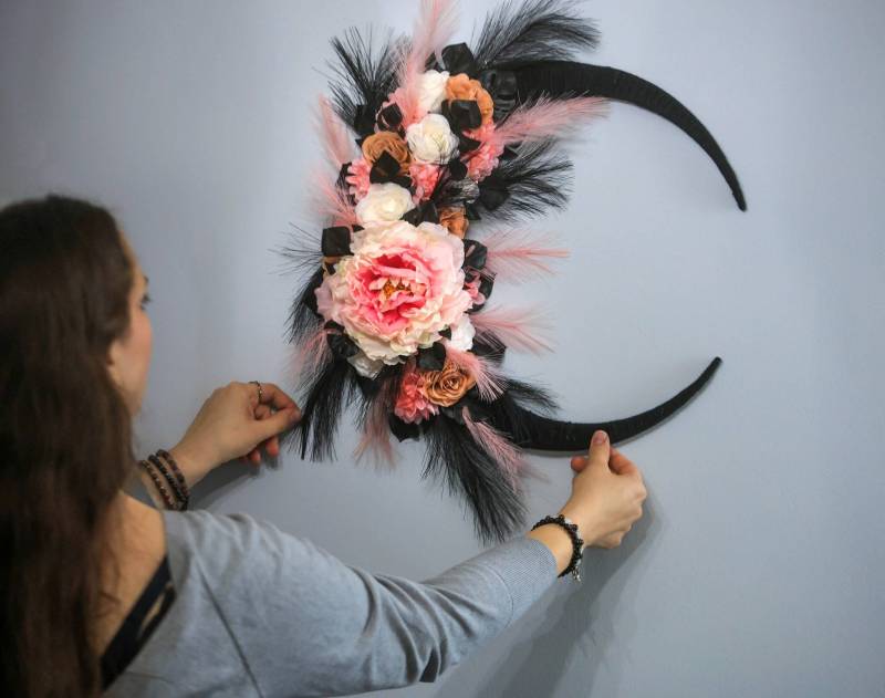 Ruth Bonneville / Free Press
Fox and Peony Creations artist Sara LeClair works on her lunar- and nature-themed wreathes at home.