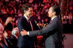 (Mike Sudoma / The Canadian Press)Manitoba Premier Wab Kinew, right, greets Prime Minister Justin Trudeau prior to the memorial service. (Mike Sudoma / The Canadian Press)
