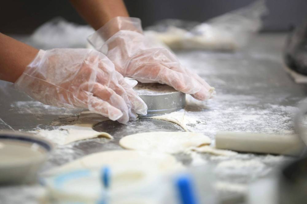 RUTH BONNEVILLE / FREE PRESS
Zegarra making his famous empanadas in a commercial kitchen in La Salle Wednesday.