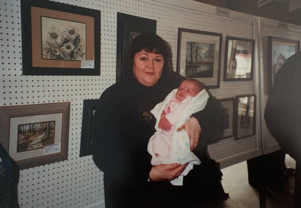 SUPPLIED
Benidickson at an exhibit of her work, holding baby Kirsten.