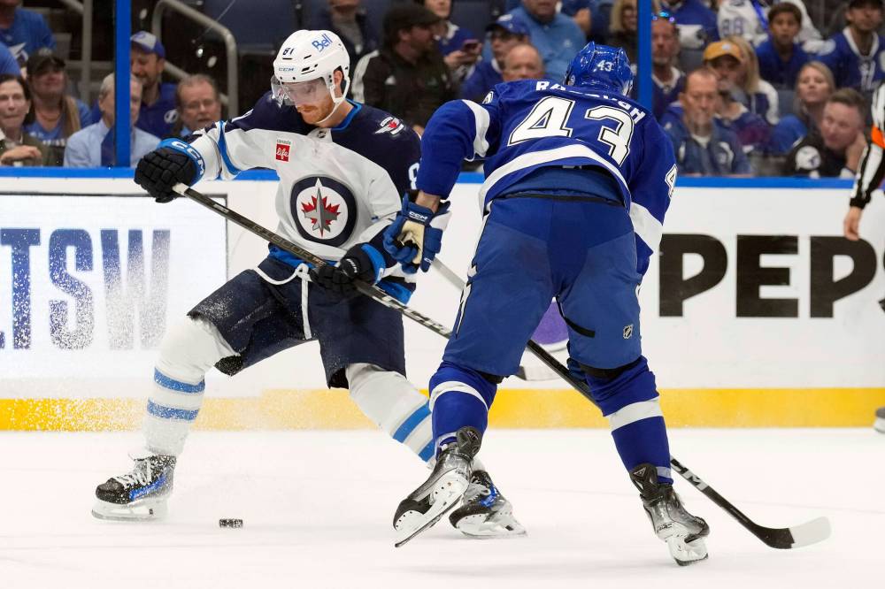 Chris O'Meara / The Associated Press
Winnipeg Jets left wing Kyle Connor tries to cut around Tampa Bay Lightning defenceman Darren Raddysh during the third period.