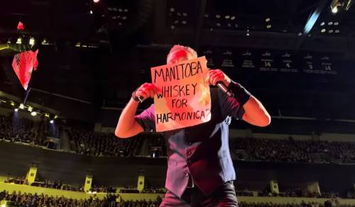 SUPPLIEDIn a still image from a video shot by Dani Pineau, Bruce Sprinsteen holds up one of the family&rsquo;s signs.