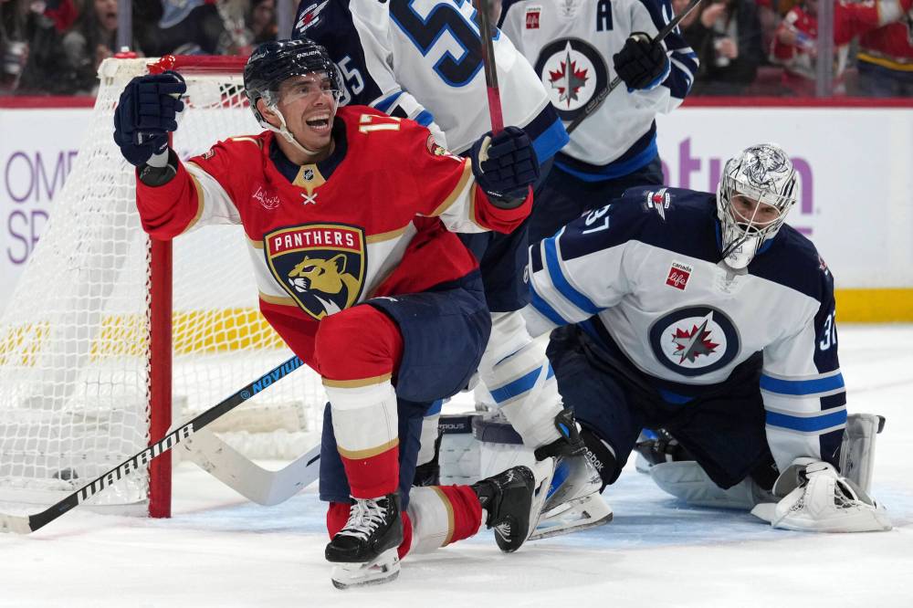 Lynne Sladky / The Associated Press
Florida Panthers centreman Evan Rodrigues, left, reacts after scoring on Winnipeg Jets goaltender Connor Hellebuyck in the second period of the Panther’s 5-0 win, Saturday in Sunrise, Fla.
