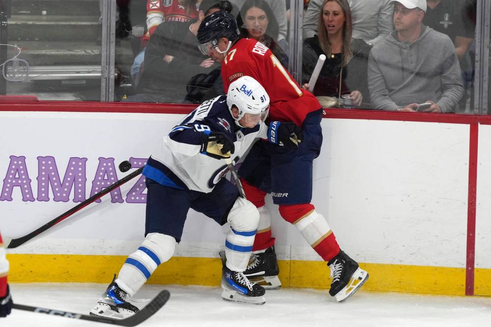Lynne Sladky / The Associated Press
Winnipeg Jets winger Cole Perfetti and Florida Panthers centreman Evan Rodrigues battle for the puck during the second period.