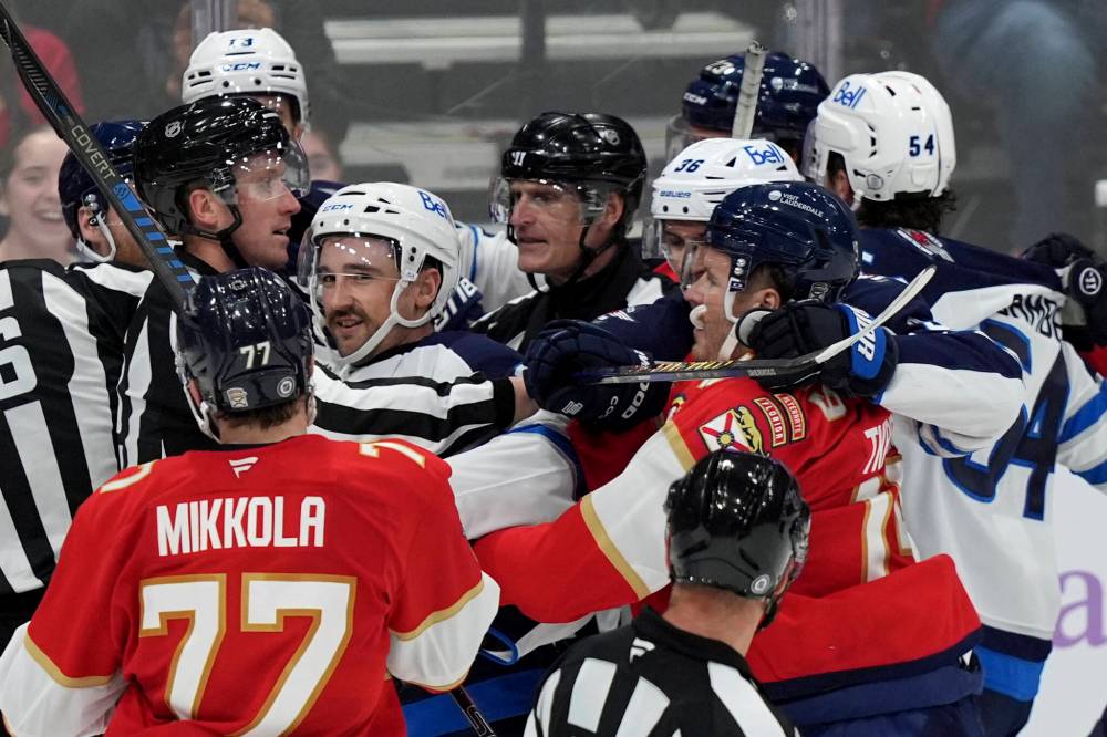 Officials break up a scuffle between the Florida Panthers and the Winnipeg Jets during the third period. (Lynne Sladky / The Associated Press files)