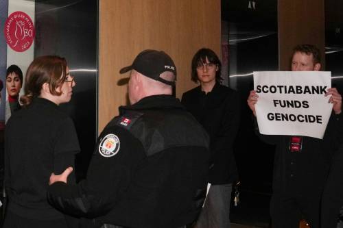Protesters are escorted out of the Four Seasons Hotel by the police after interrupting the Scotiabank Giller Prize ceremony in Toronto, on Nov. 13, 2023. (Chris Young / The Canadian Press files)