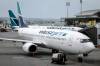 WestJet passenger jets parked at departure gates at the Calgary International Airport on Wednesday, May 31, 2023. (Jeff McIntosh / The Canadian Press files)
