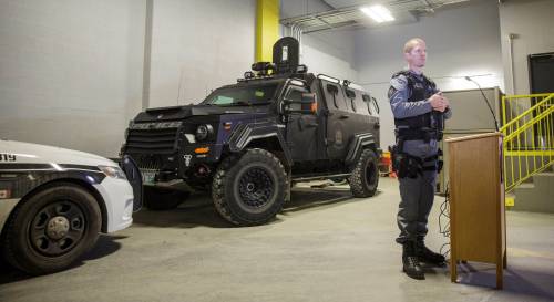 MIKE DEAL / WINNIPEG FREE PRESS Winnipeg police tactical support team member Const. Tyler Loewen discusses the role of the WPS armoured vehicle and the toll the incident took on officers at the scene in the recent shooting standoff on Bannerman while standing in front of a bullet damaged police cruiser and the ARV1 inside police headquarters. 181116 - Friday, November 16, 2018.
