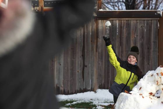 Amara Reichert throws a snowball while enjoying a snowball fight with her brother Harvey on Monday after Brandon’s first snowfall on the weekend. (Tim Smith/The Brandon Sun)