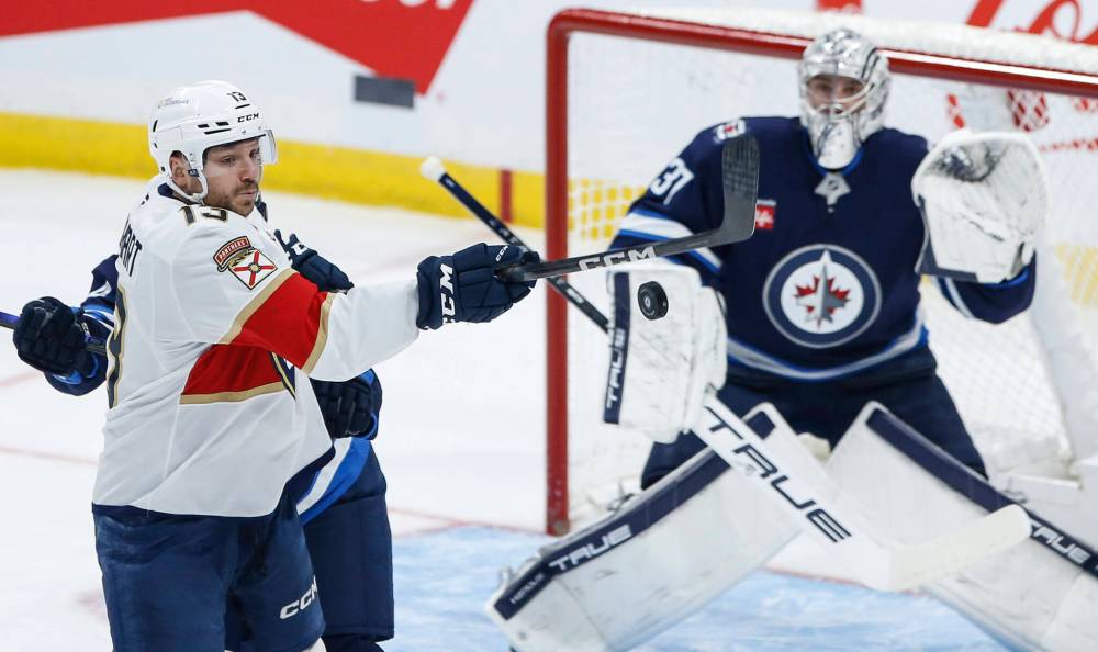 THE CANADIAN PRESS/Fred Greenslade
Florida Panthers' Sam Reinhart attempts to deflect the puck past Winnipeg Jets goaltender Connor Hellebuyck in the first period.