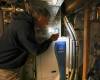 A Winnipeg homeowner shows the electric heat pump in his basement. (Ruth Bonneville / Free Press files)