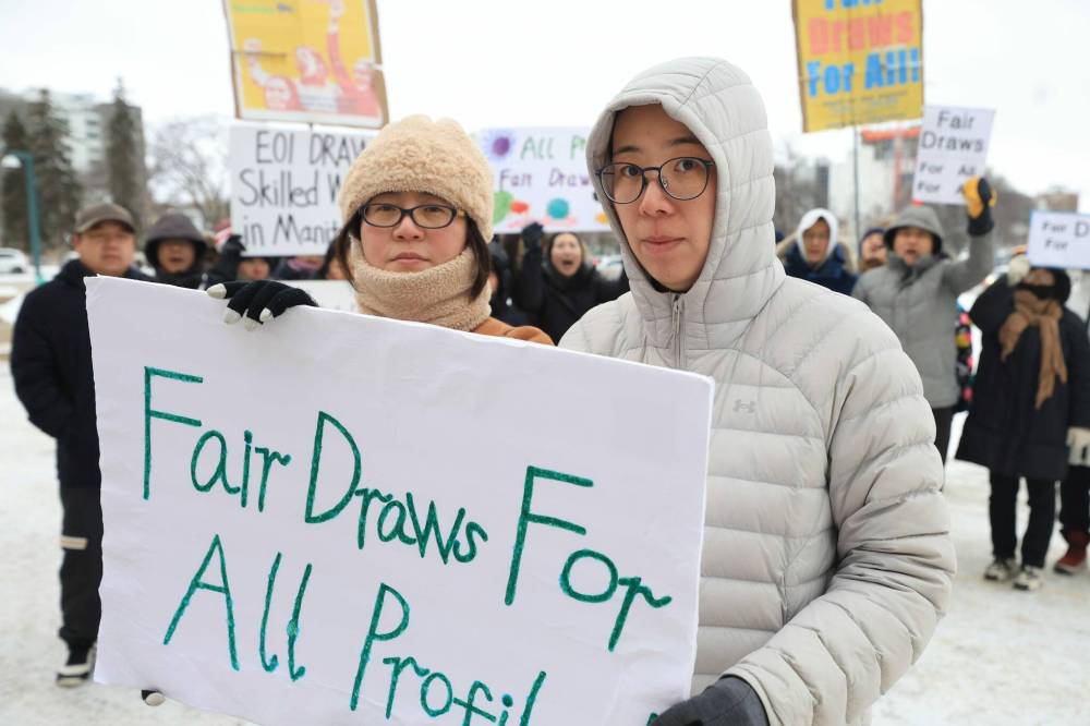 RUTH BONNEVILLE / FREE PRESS
Jing Zhang (left) and Tracy Jin, organizers with the Skilled Workers of Manitoba group, at Wednesday morning’s protest at the Manitoba legislature
