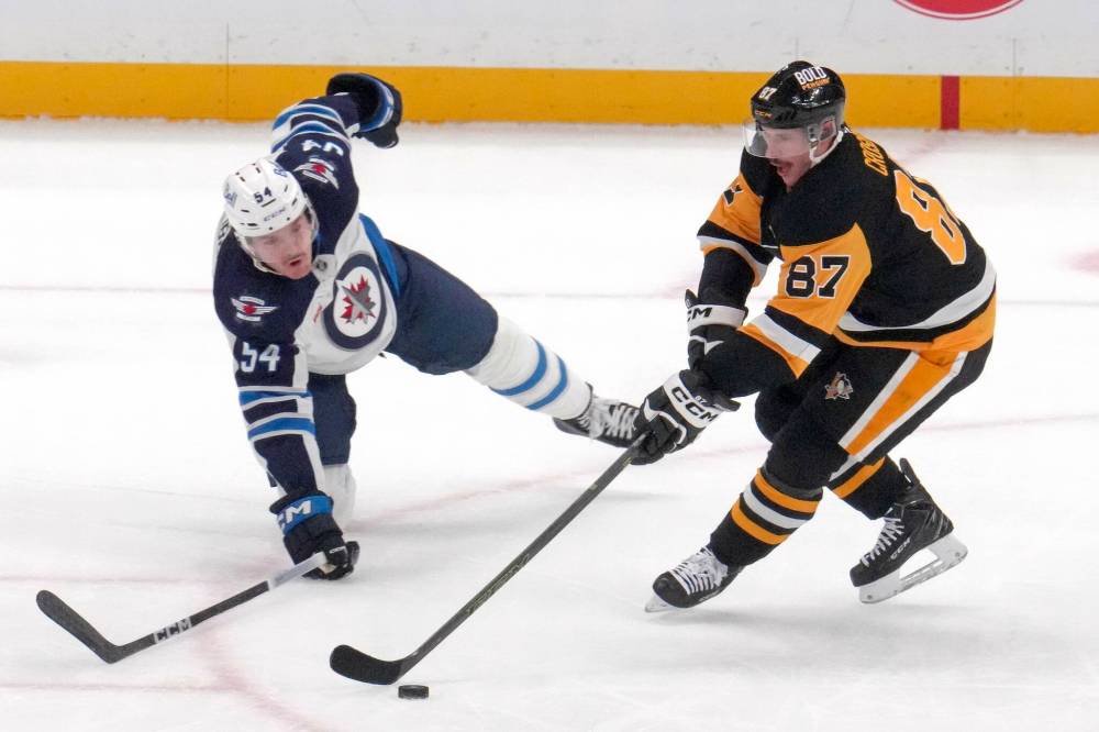 Dylan Samberg defends against Pittsburgh Penguins’ Sidney Crosby in Friday’s game in Pittsburgh. (Gene J. Puskar/Associated Press files)