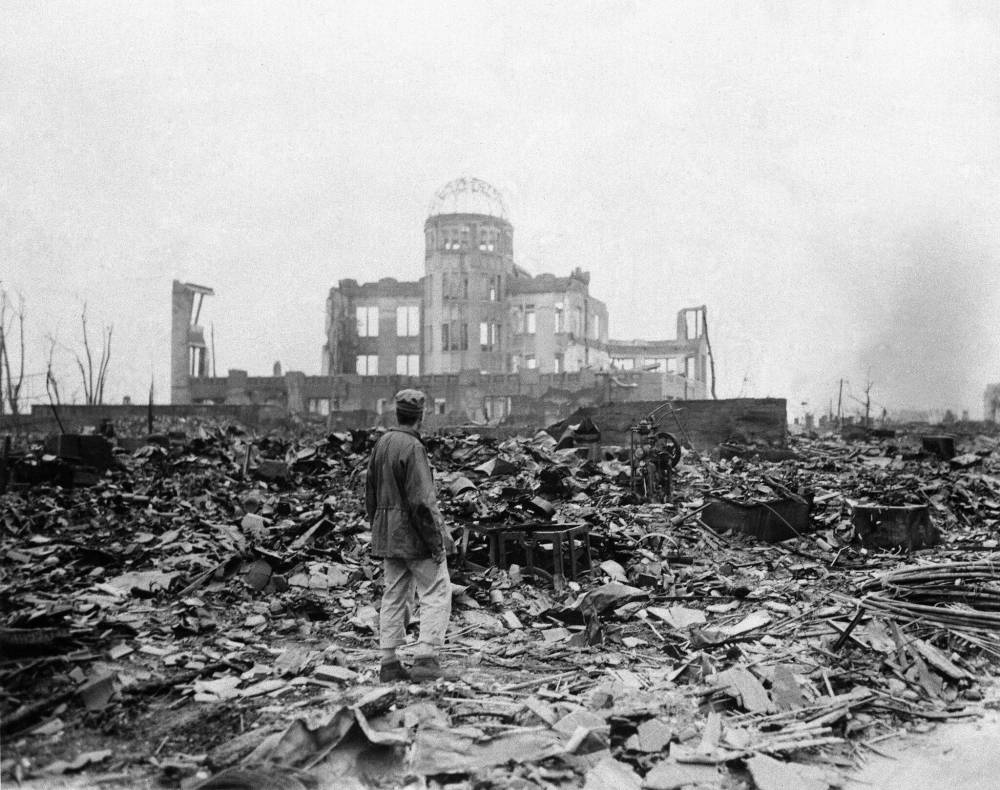 Stanley Troutman / Associated Press Files
This Sept. 8, 1945, photo shows an allied correspondent standing in the rubble in front of the shell of a building that once was a movie theatre in Hiroshima, Japan, a month after the first atomic bomb used in warfare was dropped by the U.S. on Aug. 6, 1945. The effects of modern nuclear weapons would be far worse.