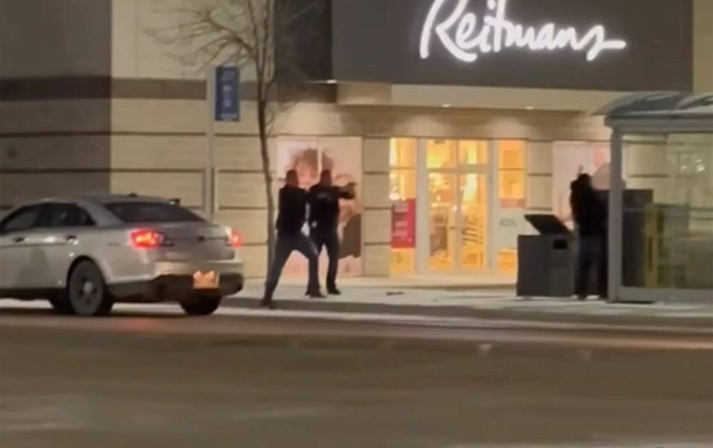 SCREEN CAPTURE A video circulating widely on social media shows Winnipeg police shooting and killing a male outside a bus shelter at Unicity shopping centre Sunday after they say he stabbed an officer in the throat.