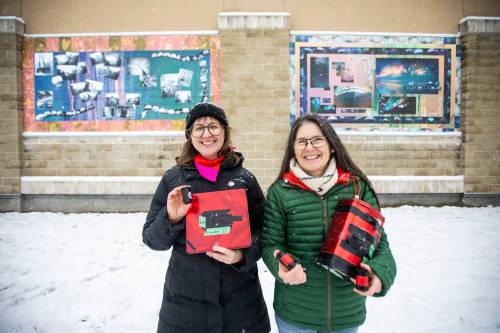 MIKAELA MACKENZIE / FREE PRESS
                                Workshop participant Jess Klassen (left) and artist Sarah Crawley in front of the new murals