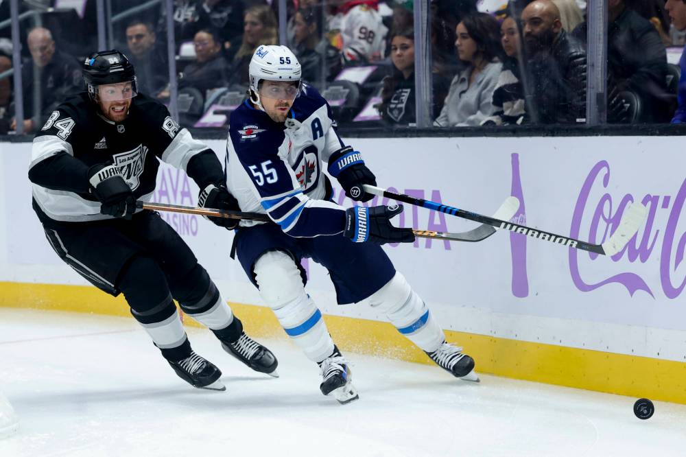 Winnipeg Jets centre Mark Scheifele moves the puck past Los Angeles Kings defenceman Vladislav Gavrikov in the first period. (AP Photo/Ryan Sun)