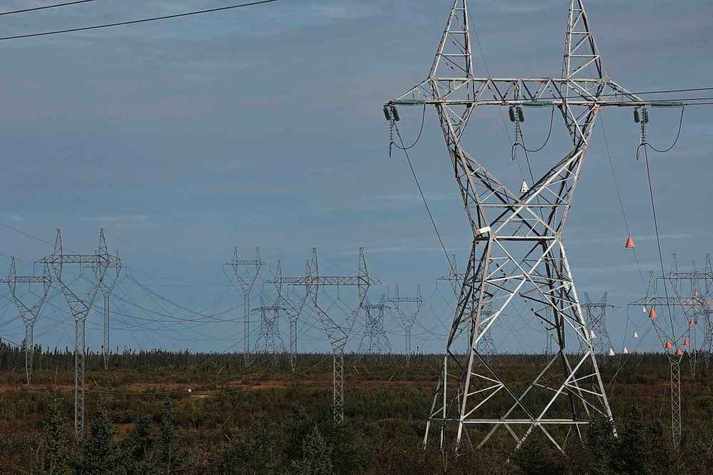 Manitoba Hydro transmission lines stretch over the forest, bogs and rivers that border the Nelson River north of Gillam, Manitoba. (Tim Smith / The Narwhal)