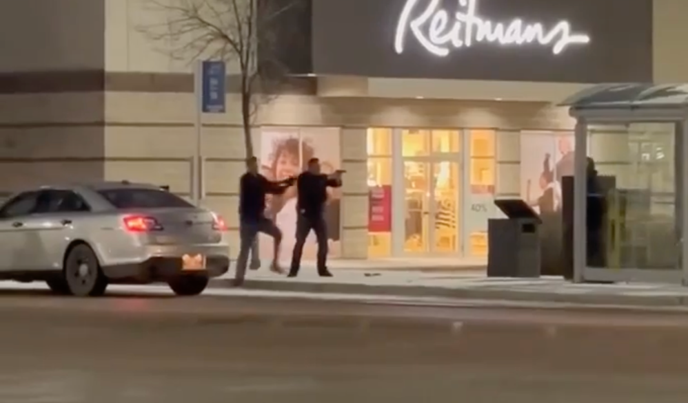 A video circulating widely on social media appears to show two police officers shouting at a man to drop an axe or a knife, and then shooting him when he takes a step toward them. (Screen capture from video)