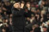 Manchester City manager Pep Guardiola reacts after Manchester City's Jeremy Doku scores his sides third goal during a Premier League soccer match against Nottingham Forest at the Etihad Stadium, Wednesday, Dec. 4, 2024, in Manchester, England. (Martin Rickett/PA via AP)