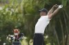 Tiger Woods stretches during an interview during the first round of the Hero World Challenge PGA Tour at the Albany Golf Club, in New Providence, Bahamas, Thursday, Dec. 5, 2024. (AP Photo/Fernando Llano)