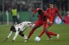 Bayern's Alphonso Davies, right, fights for the ball with Leverkusen's Jeremie Frimpong during a German Cup round of 16 soccer match between Bayern Munich and Bayer Leverkusen at the Allianz Arena in Munich, Germany, Monday. Dec.3, 2024. THE CANADIAN PRESS/AP-Matthias Schrader
