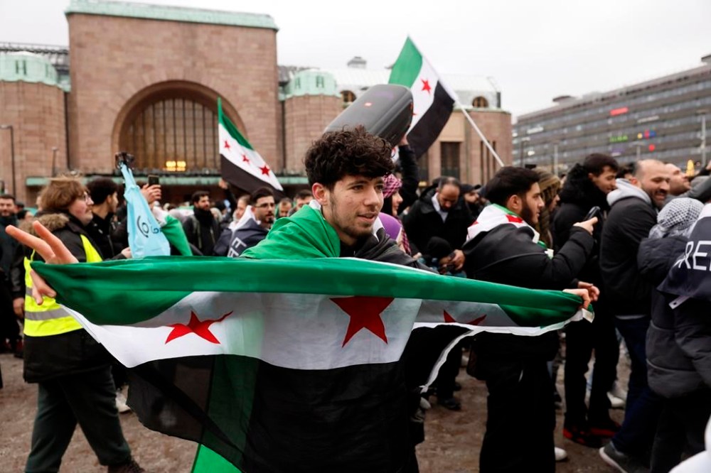Members of the Syrian community in Finland wave a Syrian flags and celebrate in Helsinki, Finland, Dec. 8, 2024. (Roni Rekomaa/Lehtikuva via AP)