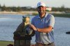 Scottie Scheffler, of the United States, poses with the championship trophy after the final round of the Hero World Challenge PGA Tour at the Albany Golf Club in New Providence, Bahamas, Sunday, Dec. 8, 2024. (AP Photo/Fernando Llano)