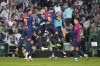 Barcelona players celebrate after Barcelona's Ferran Torres scored his side's second goal during a Spanish La Liga soccer match between Betis and Barcelona at the Benito Villamarin stadium in Seville, Spain, Saturday, Dec. 7, 2024. (AP Photo/Jose Breton)