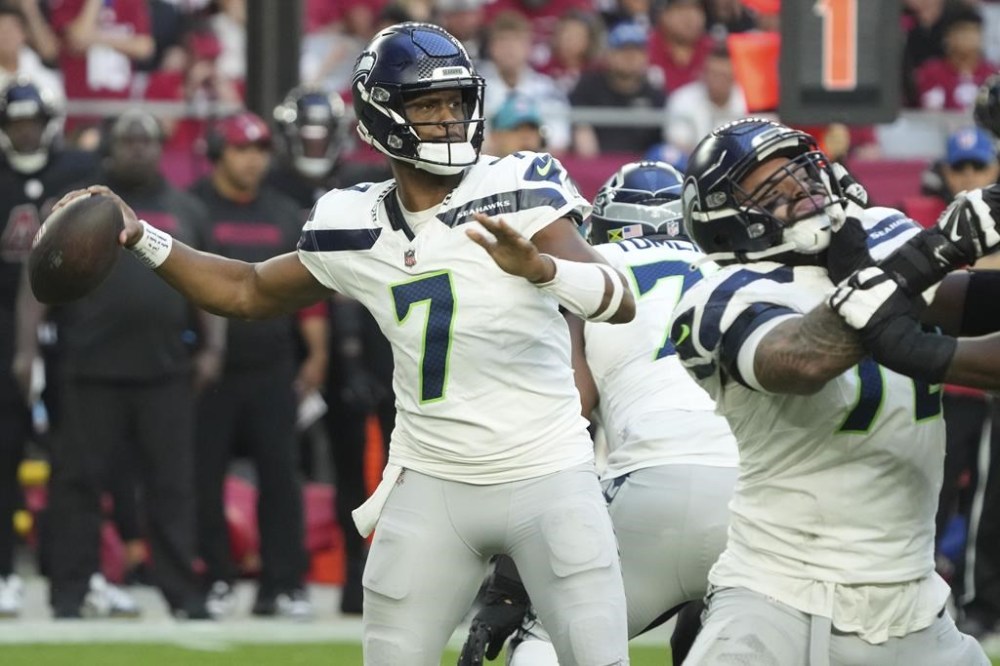 Seattle Seahawks quarterback Geno Smith (7) throws against the Arizona Cardinals during the second half of an NFL football game, Sunday, Dec. 8, 2024, in Glendale, Ariz. (AP Photo/Rick Scuteri)