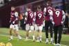 West Ham United players wear the shirt of team-mate Michail Antonio before the English Premier League soccer match between West Ham and Wolverhampton at the London Stadium, London, Monday, Dec. 9, 2024. (Zac Goodwin/PA via AP)