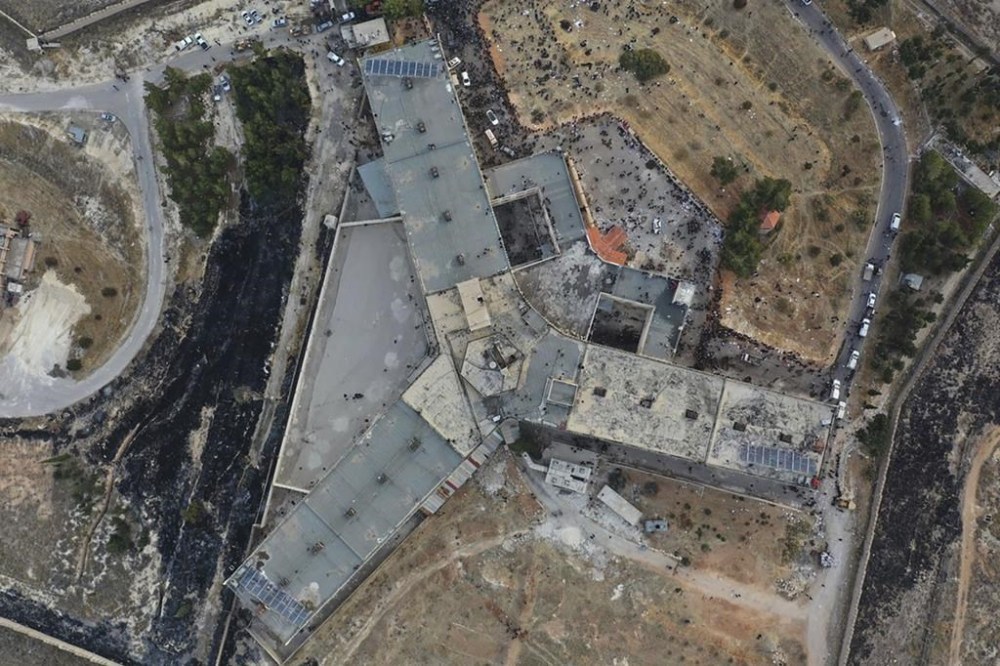 An arial view shows the infamous Saydnaya military prison, just north of Damascus, Syria, Monday, Dec. 9, 2024. Crowds are gathering to enter the prison, known as the