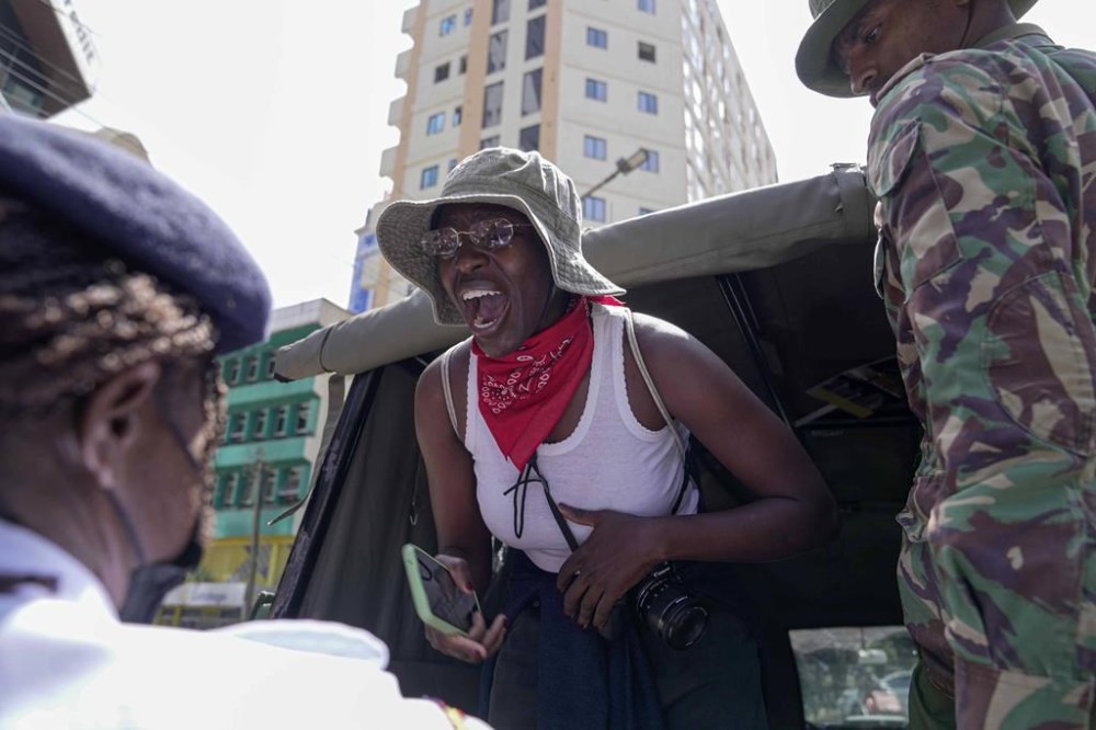 A woman shouts as Kenya anti riot police arrest her during a march against the rising cases of femicide, in downtown Nairobi, Kenya, Tuesday, Dec. 10, 2024. (AP Photo/Brian Inganga)