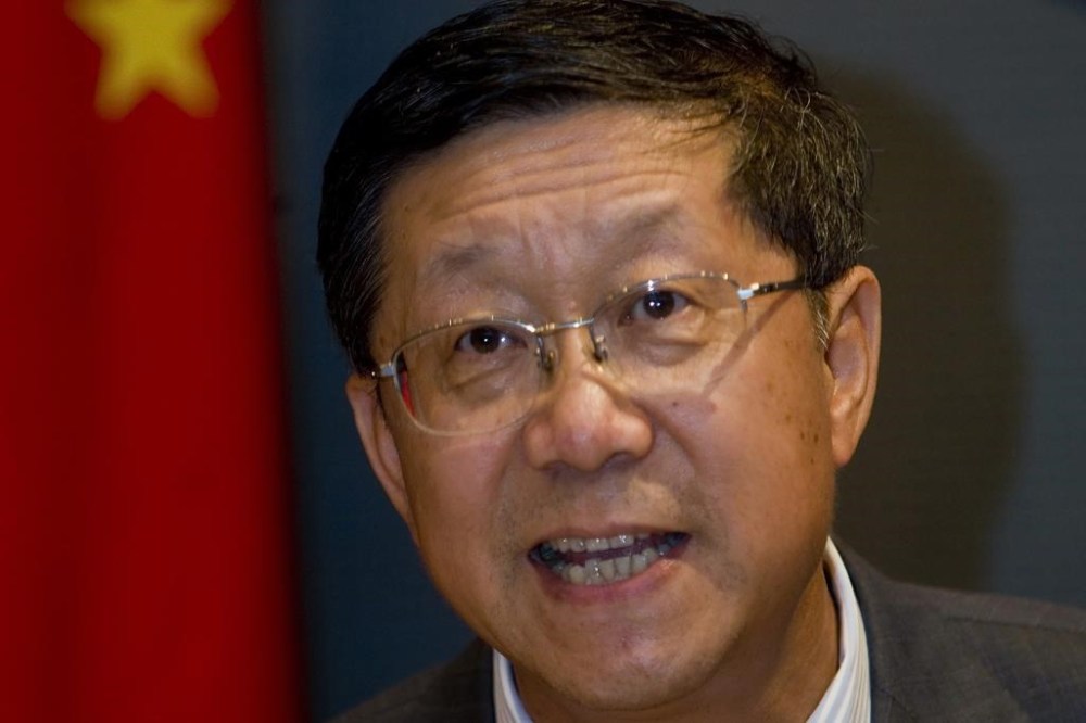 FILE - Tang Shuangning, then chairman of China Everbright Group and Everbright Securities Co., talks to the press after the IPO for Everbright Securities at Shanghai Stock Exchange in Shanghai, China on Aug. 18, 2009. (Chinatopix via AP, File)