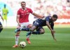 Vancouver Whitecaps' Ralph Priso, front right, is upended by Wrexham's Sam Dalby during the first half of an international friendly soccer match, in Vancouver, on Saturday, July 27, 2024. The Whitecaps have locked up a pair of midfielders, signing J.C. Ngando and Priso to new contracts.THE CANADIAN PRESS/Darryl Dyck