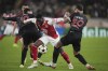 Monaco's Folarin Balogun, center, Benfica's Orkun Kokcu, left, and Nicolas Otamendi fight for the ball during a Champions League opening phase soccer match at the Louis II stadium in Monaco, Wednesday, Nov. 27, 2024. (AP Photo/Laurent Cipriani)