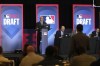 Jeff Pfeifer, at podium, MLB vice president of baseball operations, listens to a pick made by a San Diego Padres representative, standing right, during the Rule 5 Draft at the Major League Baseball winter meetings in Dallas, Wednesday, Dec. 11, 2024. (AP Photo/Tony Gutierrez)