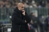Manchester City's head coach Pep Guardiola watches his players during the Champions League, opening phase soccer match between Juventus and Manchester City at the Allianz stadium in Turin, Italy, Tuesday, Wednesday, Dec.11, 2024. (AP Photo/Luca Bruno)