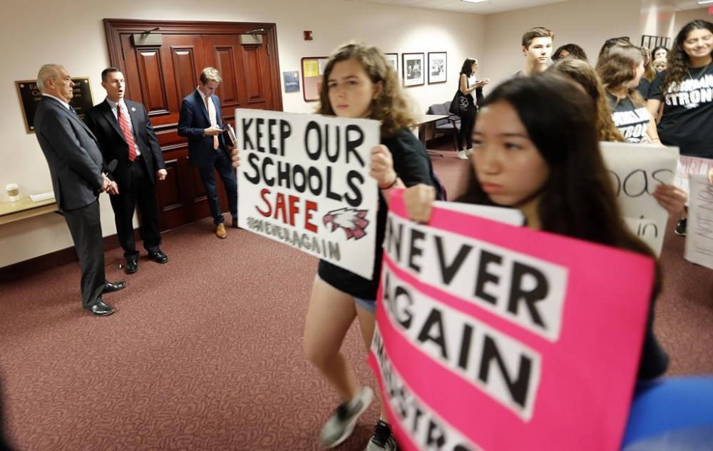 FILE - Student survivors from Marjory Stoneman Douglas High School, where 17 students and faculty were killed in a mass shooting, walk past the house legislative committee room to talk to legislators at the state Capitol regarding gun control legislation in Tallahassee, Fla., Feb. 21, 2018. (AP Photo/Gerald Herbert, File)