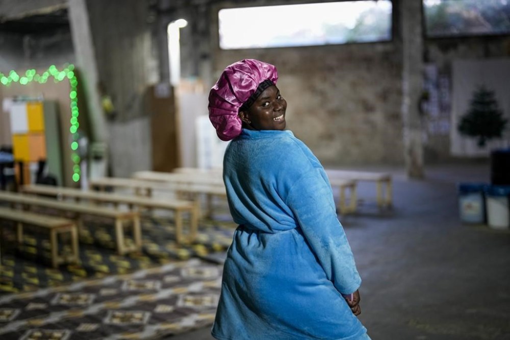 A Sierra Leonean migrant worker stranded in Lebanon, poses for a photograph as she waits to be repatriated back home, while sheltered at a former car dealership in Hazmieh, east of Beirut, Lebanon, Wednesday, Dec. 4, 2024. (AP Photo/Hassan Ammar)