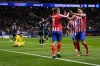 Atletico Madrid's Antoine Griezmann, left, celebrates with teammate Julian Alvarez after scoring his side's third goal during the Champions League opening phase soccer match between Atletico Madrid and Slovan Bratislava at Riyadh Air Metropolitano stadium in Madrid, Spain, Wednesday, Dec. 11, 2024. (AP Photo/Manu Fernandez)