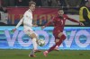 Serbia's Aleksa Terzic passes the ball by Denmark's Mads Roerslev during the UEFA Nations League soccer match between Serbia and Denmark at the Dubocica Stadium in Leskovac, Serbia, Monday, Nov. 18, 2024. (AP Photo/Darko Vojinovic)