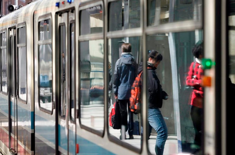 The Alberta government is proposing a reworked Green Line light rail transit route in Calgary that is says would serve more communities and save more than $1 billion. Commuters are reflected in the windows of a Calgary C-Train on Wednesday, April 2, 2008. THE CANADIAN PRESS/Jeff McIntosh
