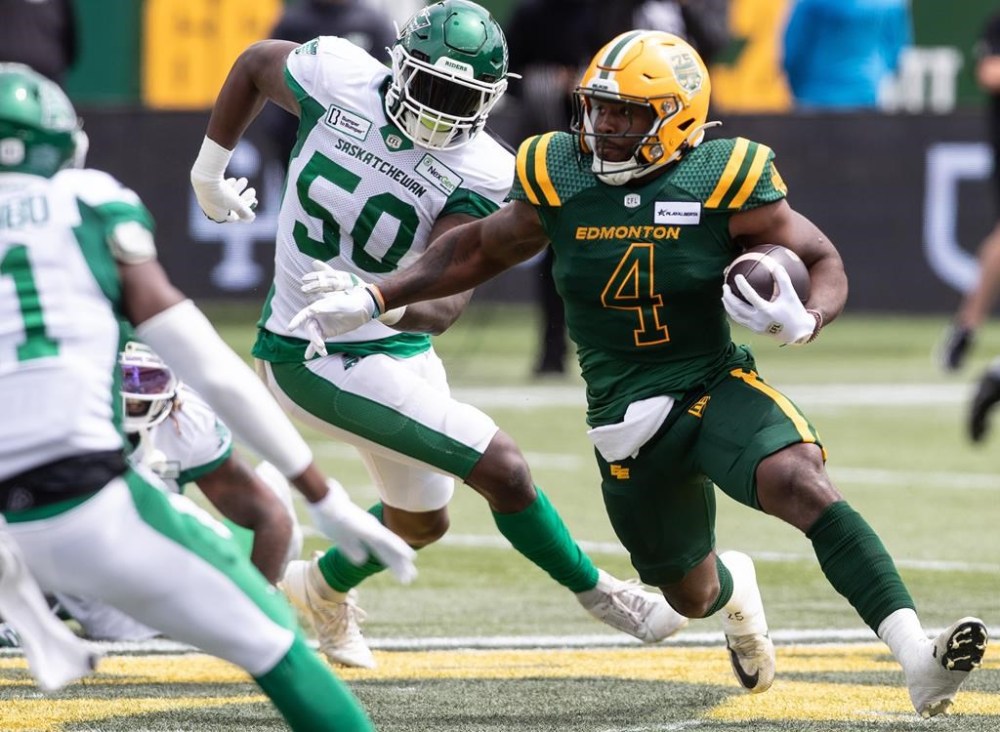 Edmonton Elks' Kevin Brown (4) carries the ball against the Saskatchewan Roughriders during first half CFL action in Edmonton, Alta., on Saturday June 8, 2024. THE CANADIAN PRESS/Jason Franson.