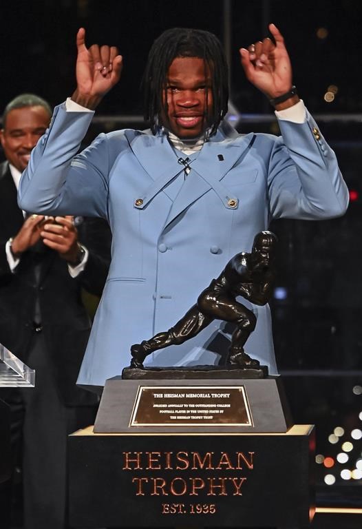 Colorado’s Travis Hunter gestures after winning the Heisman Trophy as the outstanding player in college football, Saturday, Dec. 14, 2024, in New York. (Todd Van Emst/Heisman Trust via AP, Pool)