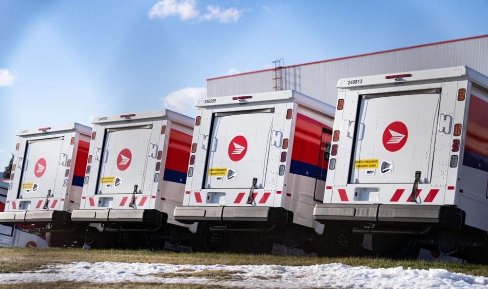 Canada Post trucks are seen in a distribution centre in Montreal on December 13, 2024. THE CANADIAN PRESS/Christinne Muschi