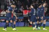 PSG's Goncalo Ramos, left, celebrates with teammates after scoring his side's third goal during the French League One soccer match between Paris Saint-Germain and Lyon at the Parc des Princes in Paris, Sunday, Dec. 15, 2024. (AP Photo/Aurelien Morissard)
