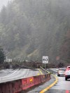 The Sea to Sky Highway linking Vancouver and Whistler, B.C., was closed in both directions this weekend after a mudslide near Lions Bay brought down trees and debris to block the road as shown in this handout image on Saturday Dec. 14, 2024. THE CANADIAN PRESS/HO-Michal Aibin