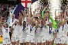 FILE - England's Leah Williamson, center left, and Millie Bright lift the trophy after winning the Women's Euro 2022 final soccer match between England and Germany at Wembley stadium in London, Sunday, July 31, 2022. England won 2-1. (AP Photo/Alessandra Tarantino, File)